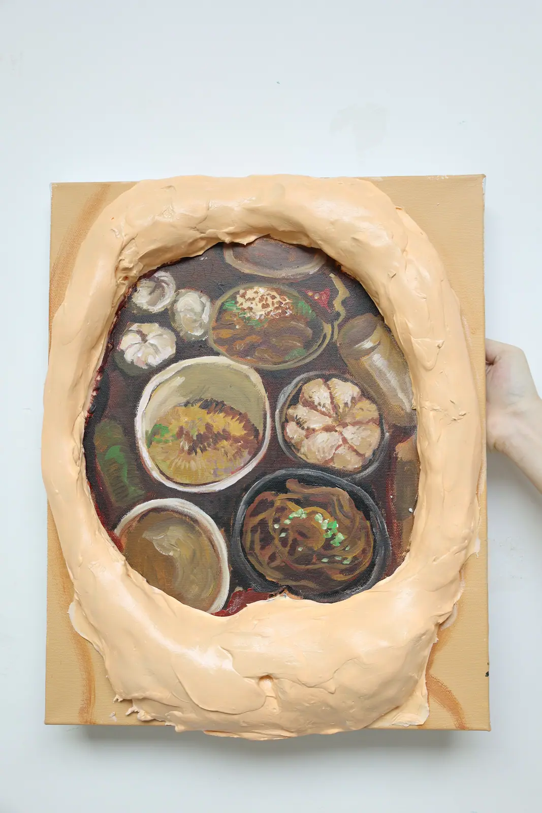 Relief of a torso opening onto a table of dishes